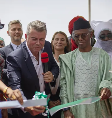 Chef for Arlas internationale forretning Simon Stevens (tv.) klipper båndet sammen med officielle repræsentanter for Nigeria