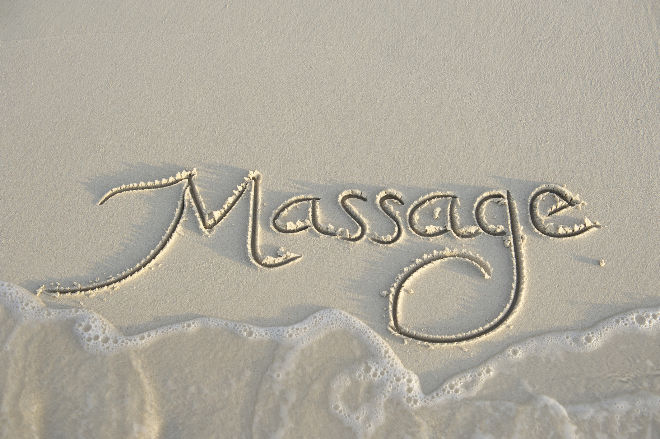 massage skrivet i sand.jpg